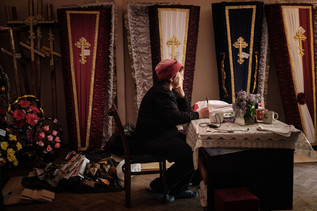 A woman named Antonina sits at a funeral home where she works and now lives with neighbors in Severodonetsk, Ukraine, on Tuesday, May 3.