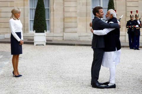French President Emmanuel Macron embraces Indian Prime Minister Narendra Modi, right, as he and his wife, Brigitte, welcomed Modi to the Elysee Palace in Paris on Wednesday, May 4.