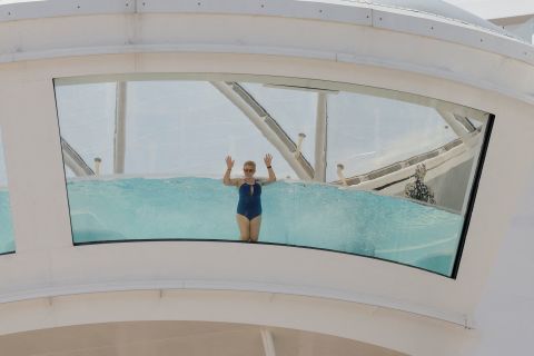 A passenger swims in a pool of a cruise ship that was docked in Malaga, Spain, on Saturday, April 30. <a href=