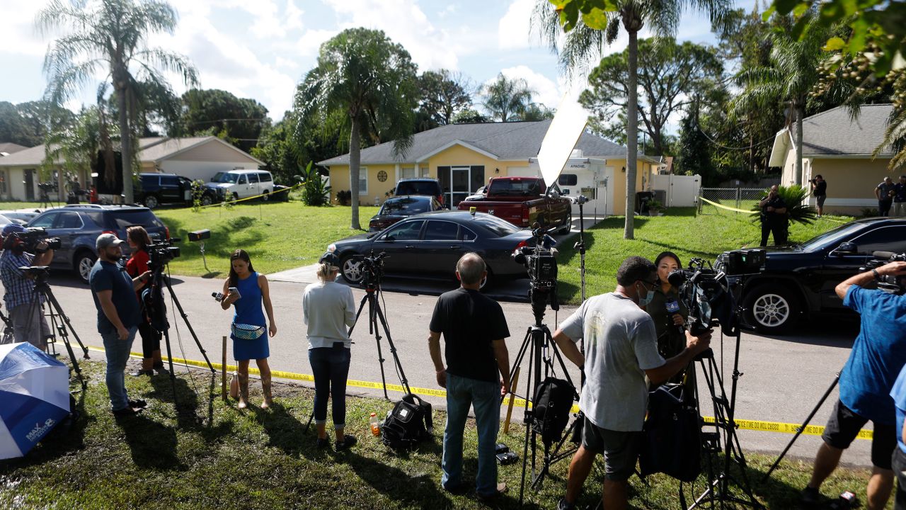 Members of the media wait near the Florida home of Brian Laundrie, who was named a person of interest after his fiancée Gabby Petito went missing in September 2021. The public remains fascinated by manhunts, and a few elements, such as a sense of an "unfinished story," play a part.