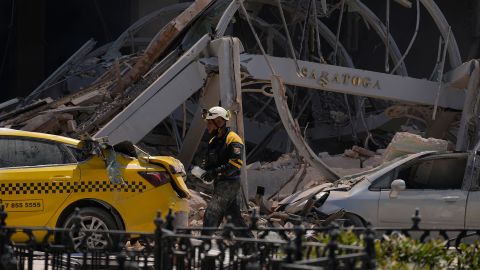A Hotel Saratoga sign hangs amid the rubble.