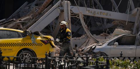 A sign from Hotel Saratoga is seen in the rubble after the building was destroyed by an explosion in Havana, Cuba, on Friday, May 6.