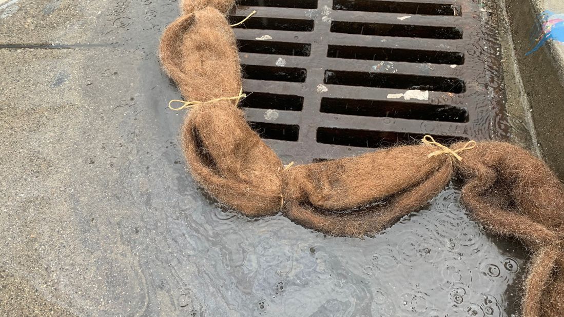 The hair mats can be rolled into booms to collect vehicle oil from the street. The goal is to keep oil out of storm drains that flow into waterways.