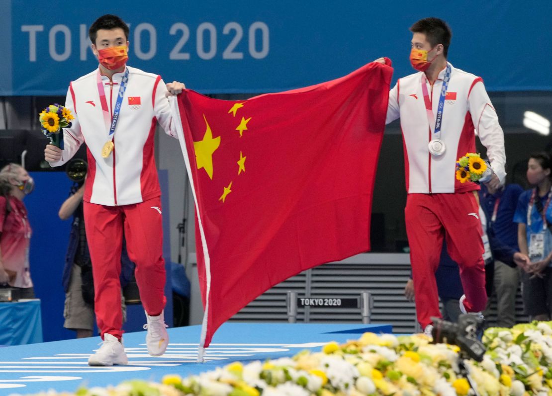 China's Cao Yuan (left) and Yang Jian celebrate their medals in the men's 10m platform final at the Tokyo Olympics. 