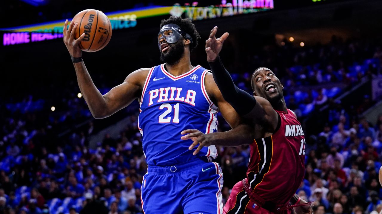 Embiid and Bam Adebayo battle for the ball during the first half.
