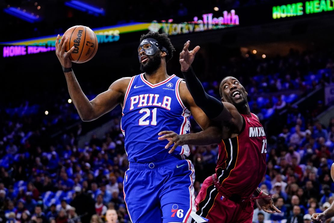 Embiid and Bam Adebayo battle for the ball during the first half.