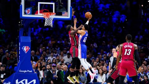 76ers' Tobias Harris goes up for a shot against Jimmy Butler.