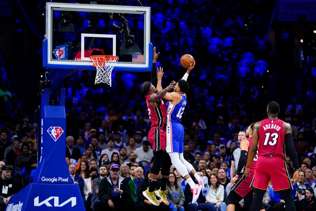76ers' Tobias Harris goes up for a shot against Jimmy Butler.