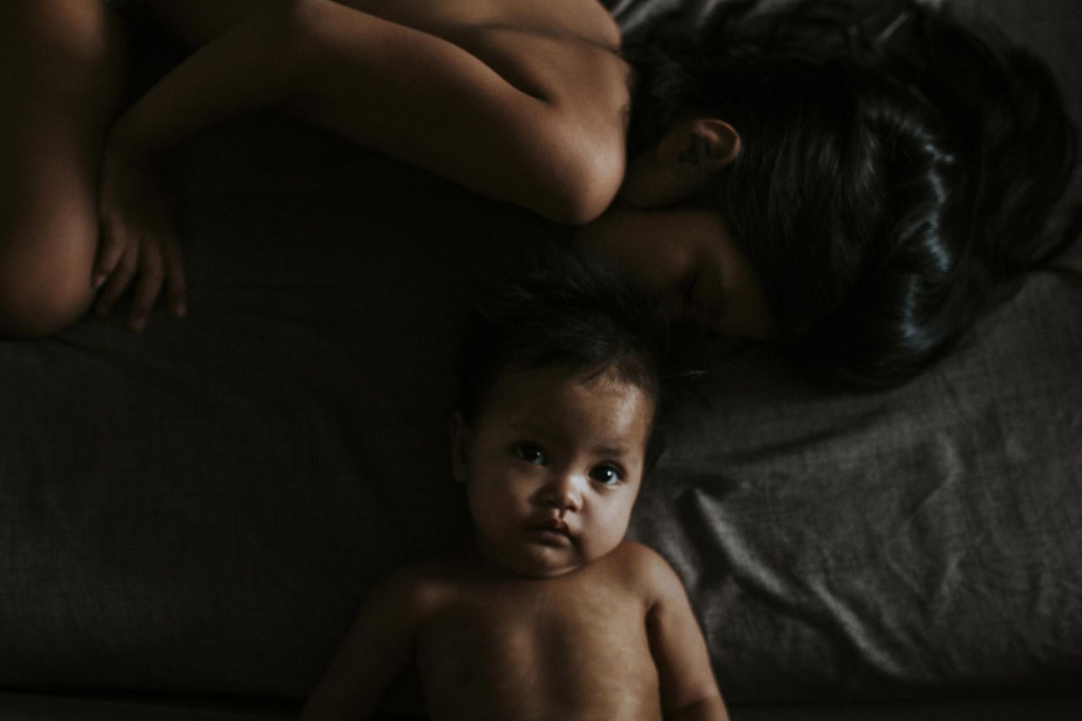 <a href="https://www.lishazulkepli.com/" target="_blank" target="_blank">Lisha Zulkepli</a> photographed her children during the pandemic as they navigated being confined to their home in Kuala Lumpur, Malaysia. "Motherhood is eating peanut butter toast you made because they wanted oatmeal instead, your oatmeal, and preparing lunches and dinners in your head for the rest of the week," she said. "Motherhood is crying with them and laughing with them, often at the same time. Motherhood is spring, summer, winter and autumn, all in one day. It is hurricanes and tornadoes, tsunamis and heat waves all rolled into one, per child. ... It is an exhausting and scary and, sometimes, a very lonely path. And more often than you care to notice, motherhood is the only reason you wake up in the morning."