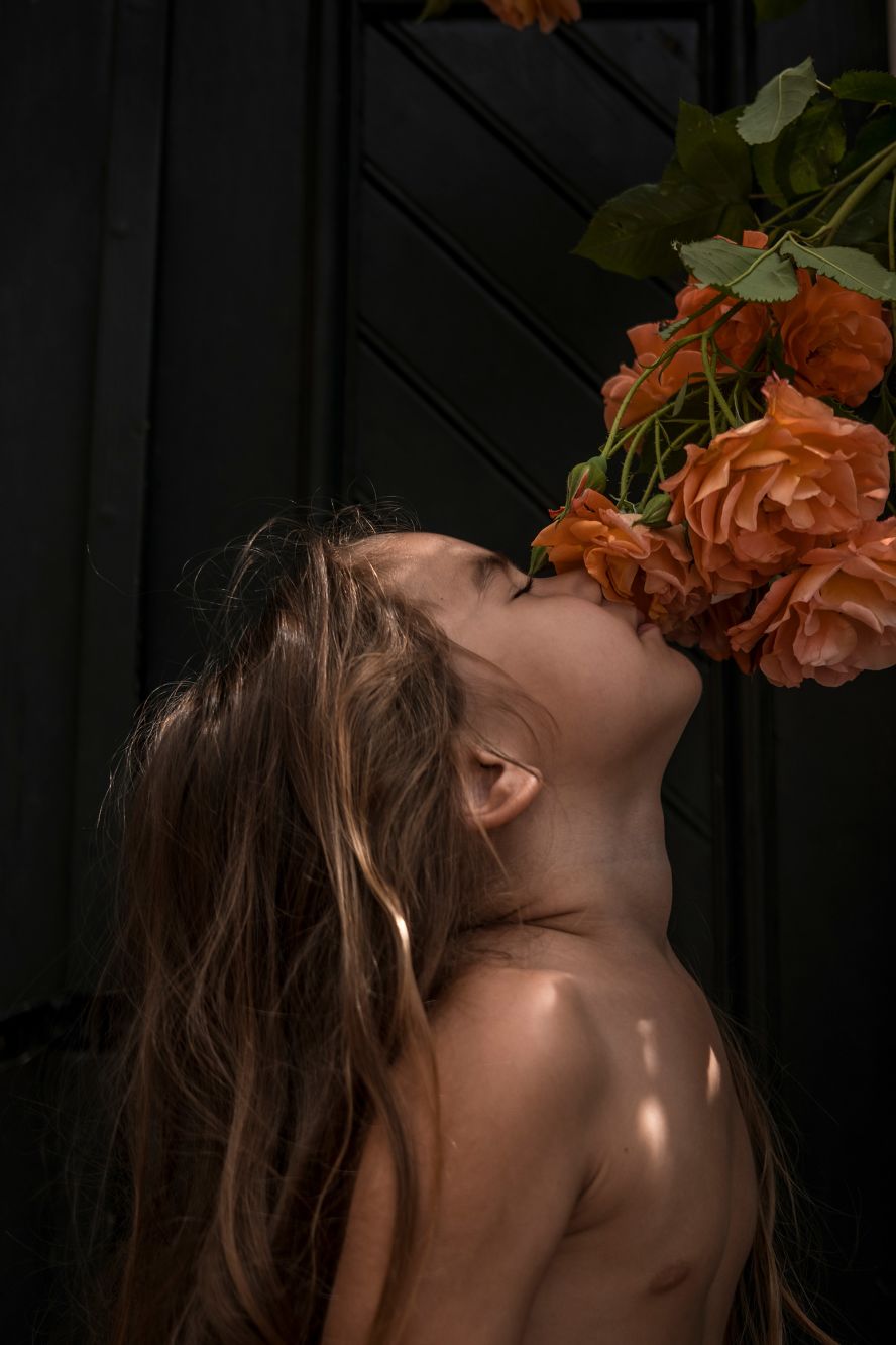 <a href="index.php?page=&url=https%3A%2F%2Fwww.sarahpabst.com%2F" target="_blank" target="_blank">Sarah Pabst's</a> daughter, Elena, smells the roses at her parents' house near Cologne, Germany. "We had arrived a month earlier from Argentina for our summer visit, escaping the rising Covid curve in our South American home country, and due to the impending birth of her baby brother," the photographer said. "My children remind me every day of the beauty in small things, the never-ending force of discovery, and the magic in the ordinary."