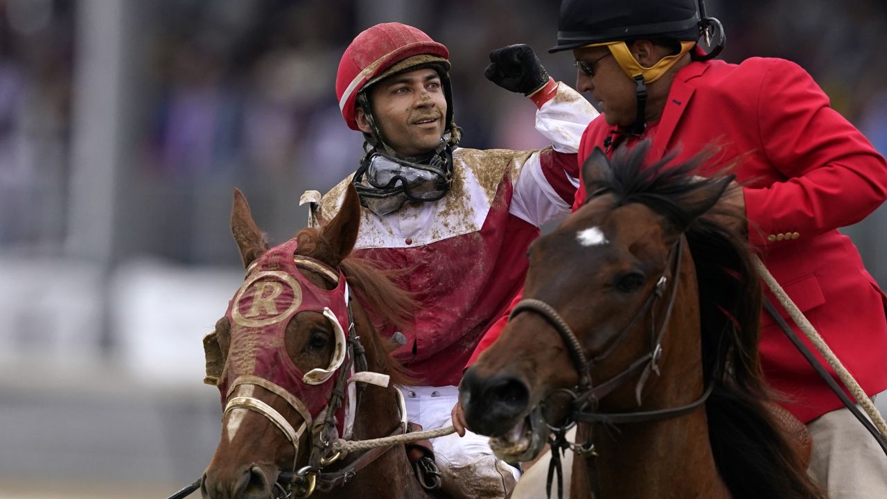 Sonny Leon celebrates after riding Rich Strike past the finish line.