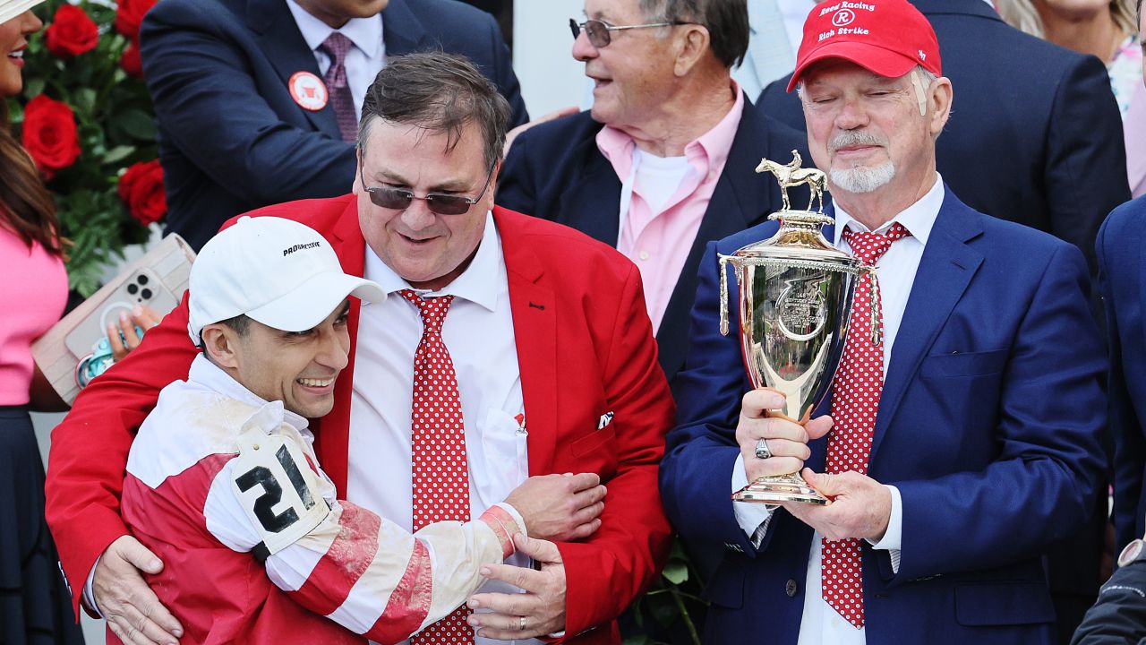 Jockey Sonny Leon hugs trainer Eric Reed after Rich Strike's victory.