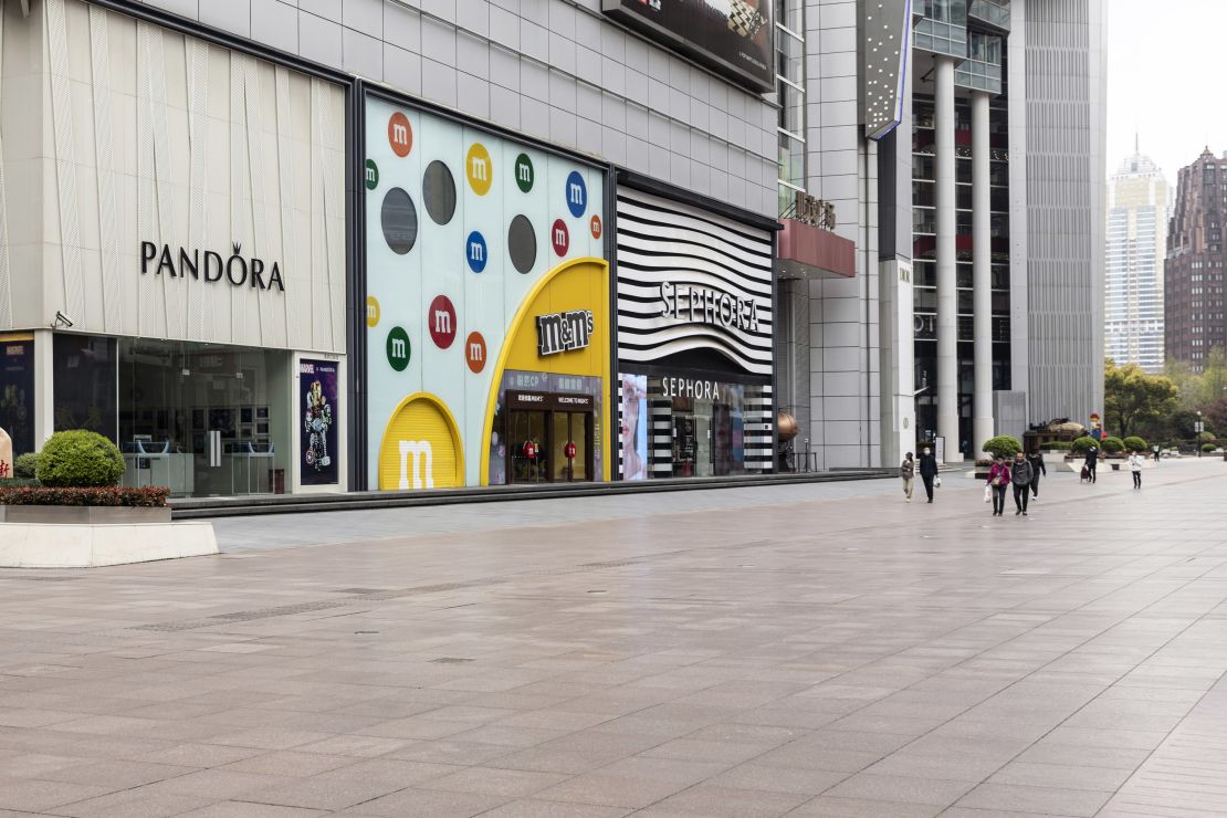 Pedestrians along the near-empty Nanjing Road shopping street outside of the impacted areas during a lockdown in Shanghai, China in March.