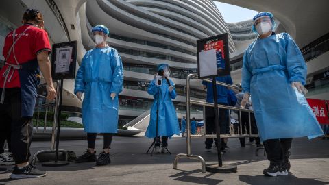 Health workers wearing protective clothing at the entrance to a Covid-19 testing site at a shopping complex in Beijing.