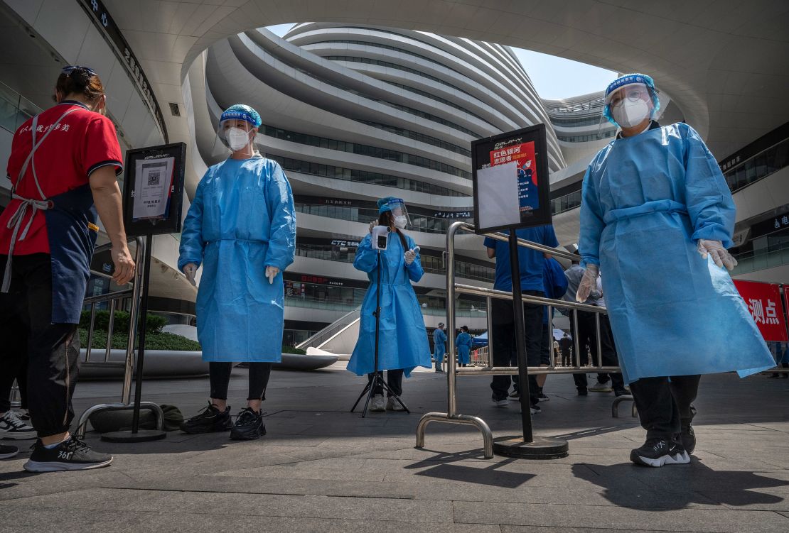 Health workers wearing protective clothing at the entrance to a Covid-19 testing site at a shopping complex in Beijing.