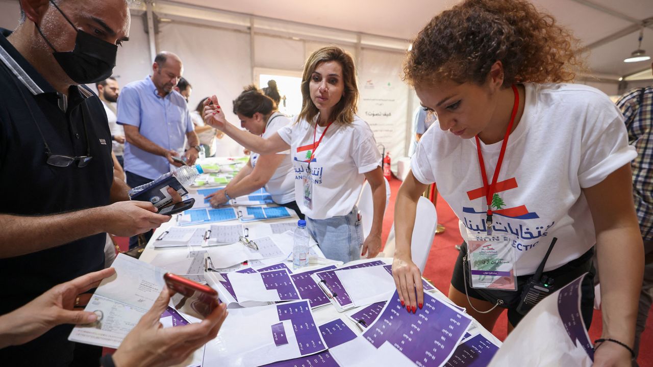 Lebanese expats check lists with electoral staff before casting their votes for the May 15 legislative election at Lebanon's consulate in  Dubai on May 8.