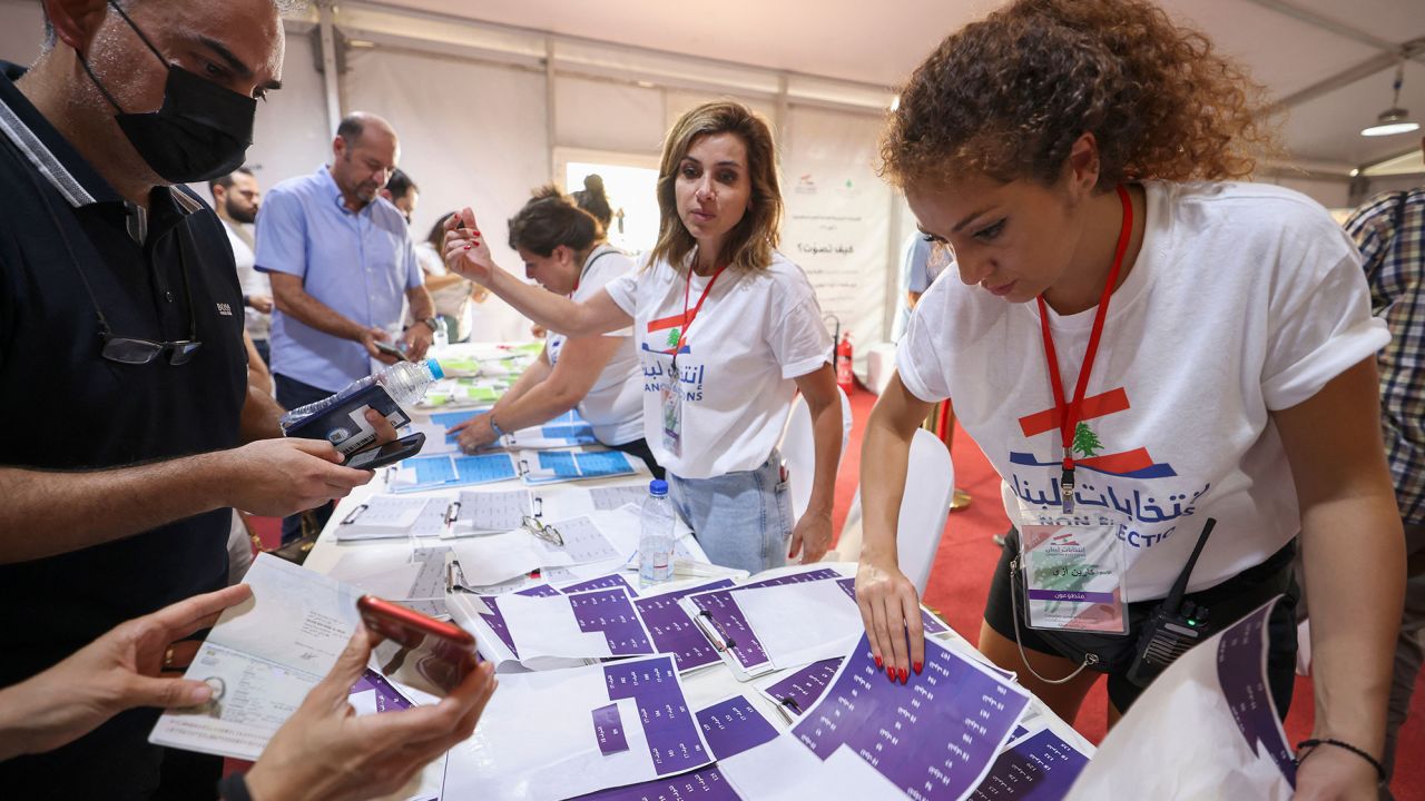 Lebanese expats check lists with electoral staff before casting their votes for the May 15 legislative election at Lebanon's consulate in Dubai on May 8.