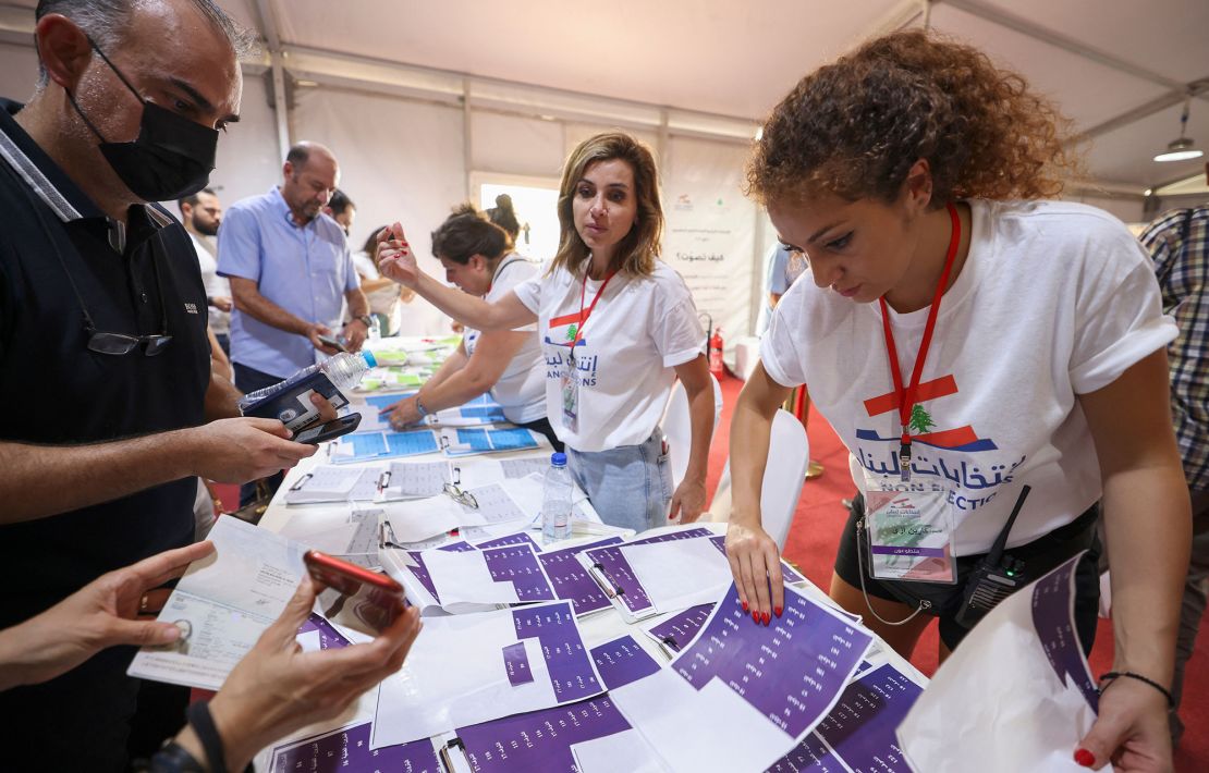 Lebanese expats check lists with electoral staff before casting their votes for the May 15 legislative election at Lebanon's consulate in  Dubai on May 8.