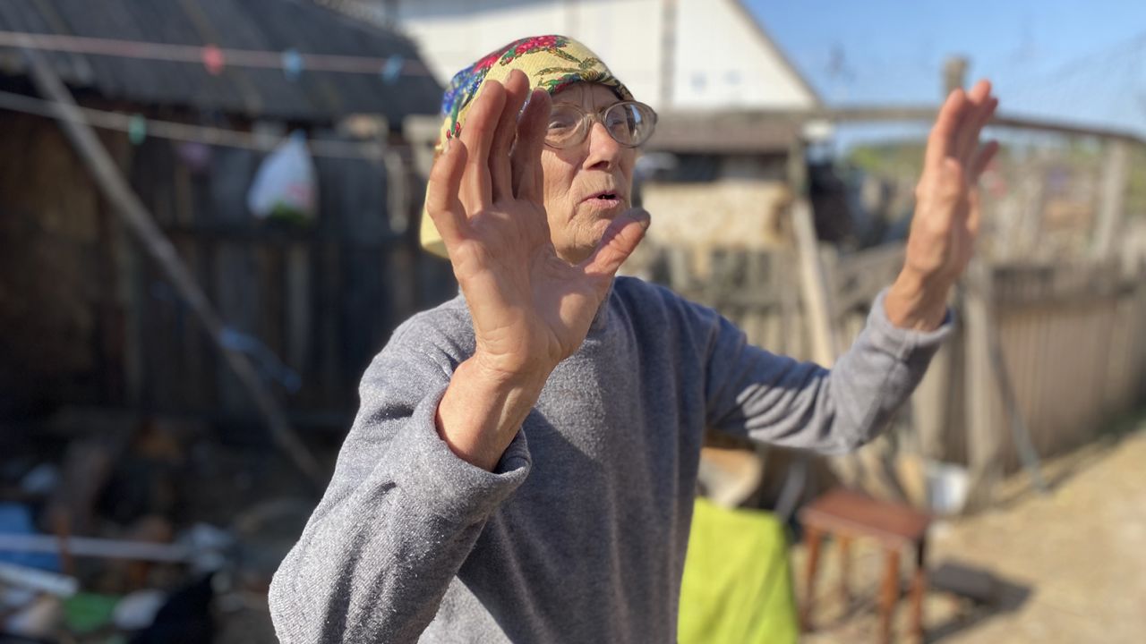 A grandmother who says she had to help bury her son-in-law after Russian troops shot him