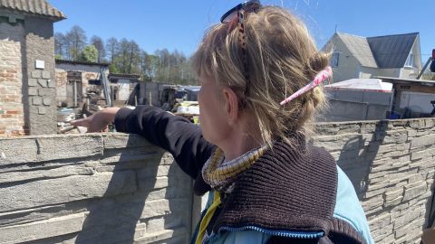 "Nika" points to a bullet hole made by Russians who she says raped her.