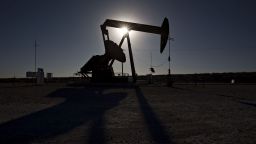 The silhouette of a pumpjack is seen in the Permian Basin near Orla, Texas, U.S., on Friday, March 2, 2018. Chevron, the world's third-largest publicly traded oil producer, is spending $3.3 billion this year in the Permian and an additional $1 billion in other shale basins. Its expansion will further bolster U.S. oil output, which already exceeds 10 million barrels a day, surpassing the record set in 1970. Photographer: Daniel Acker/Bloomberg via Getty Images