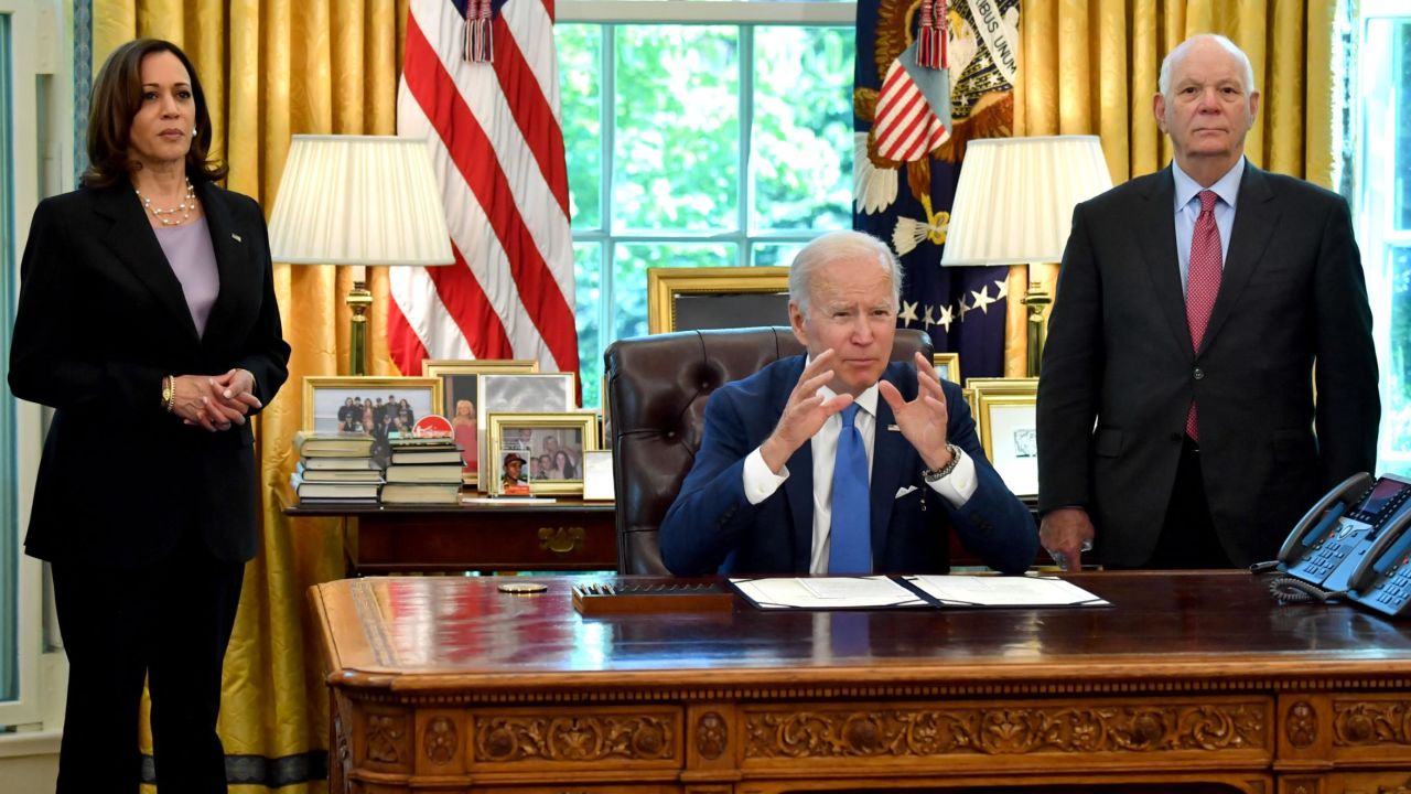 US Vice President Kamala Harris (L) and US Senator Ben Cardin (D-MD) (R) listen as US President Joe Biden speaks after signing into law the Ukraine Democracy Defense Lend-Lease Act of 2022, in the Oval Office of the White House in Washington, DC, on May 9, 2022. (Photo by Nicholas Kamm / AFP) (Photo by NICHOLAS KAMM/AFP via Getty Images)