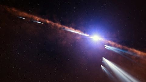This illustration shows exocomets orbiting the nearby star Beta Pictoris. Astronomers have detected at least 30 exocomets in the system, which also hosts two exoplanets.