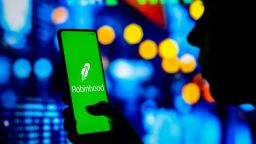 BRAZIL - 2022/04/12: In this photo illustration, a woman holds a smartphone with the Robinhood Markets logo displayed on the screen. (Photo Illustration by Rafael Henrique/SOPA Images/LightRocket via Getty Images)
