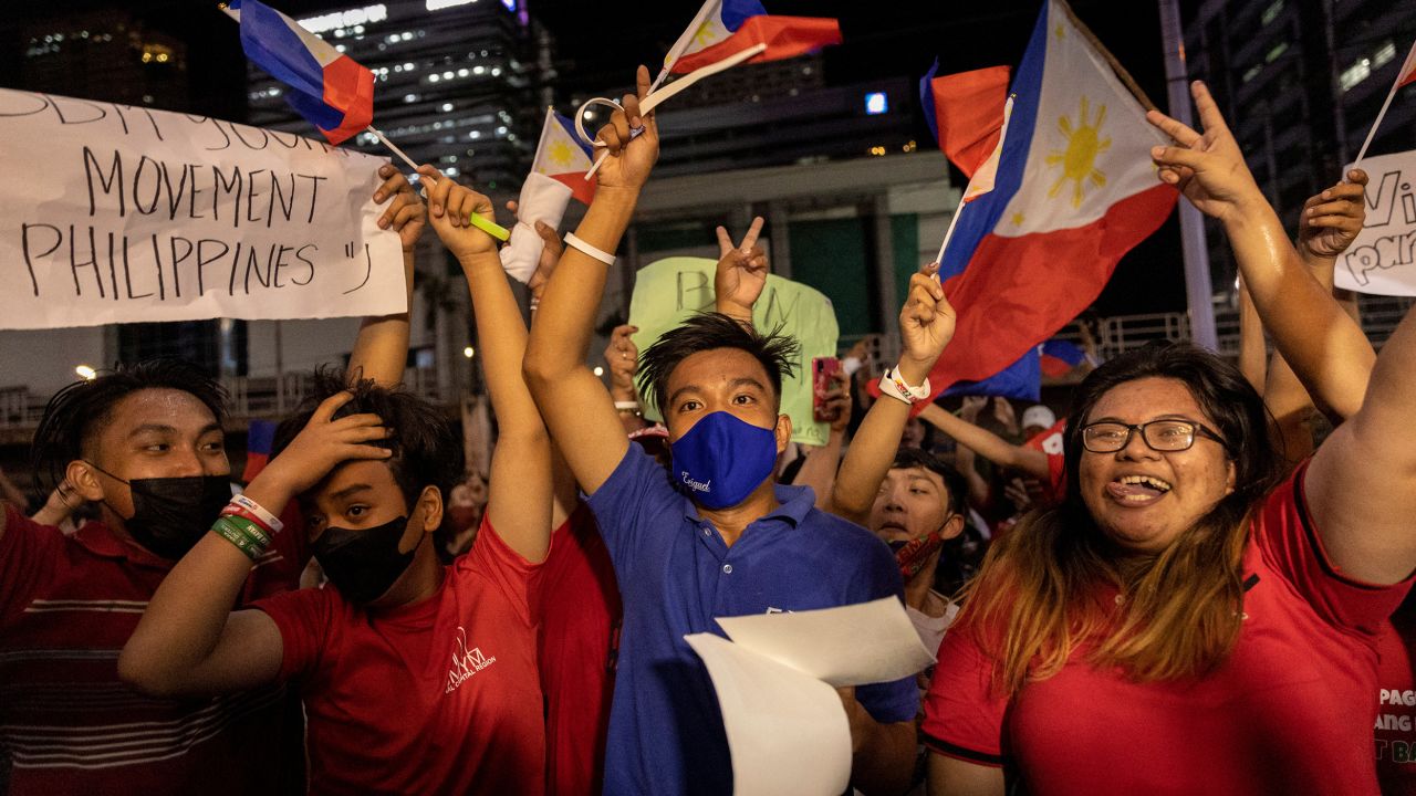 Supporters of presidential candidate Ferdinand "Bongbong" Marcos Jr. celebrate as partial results of the 2022 national elections show him with a wide lead over rivals, outside the candidate's headquarters in Mandaluyong City, Philippines, on May 9.