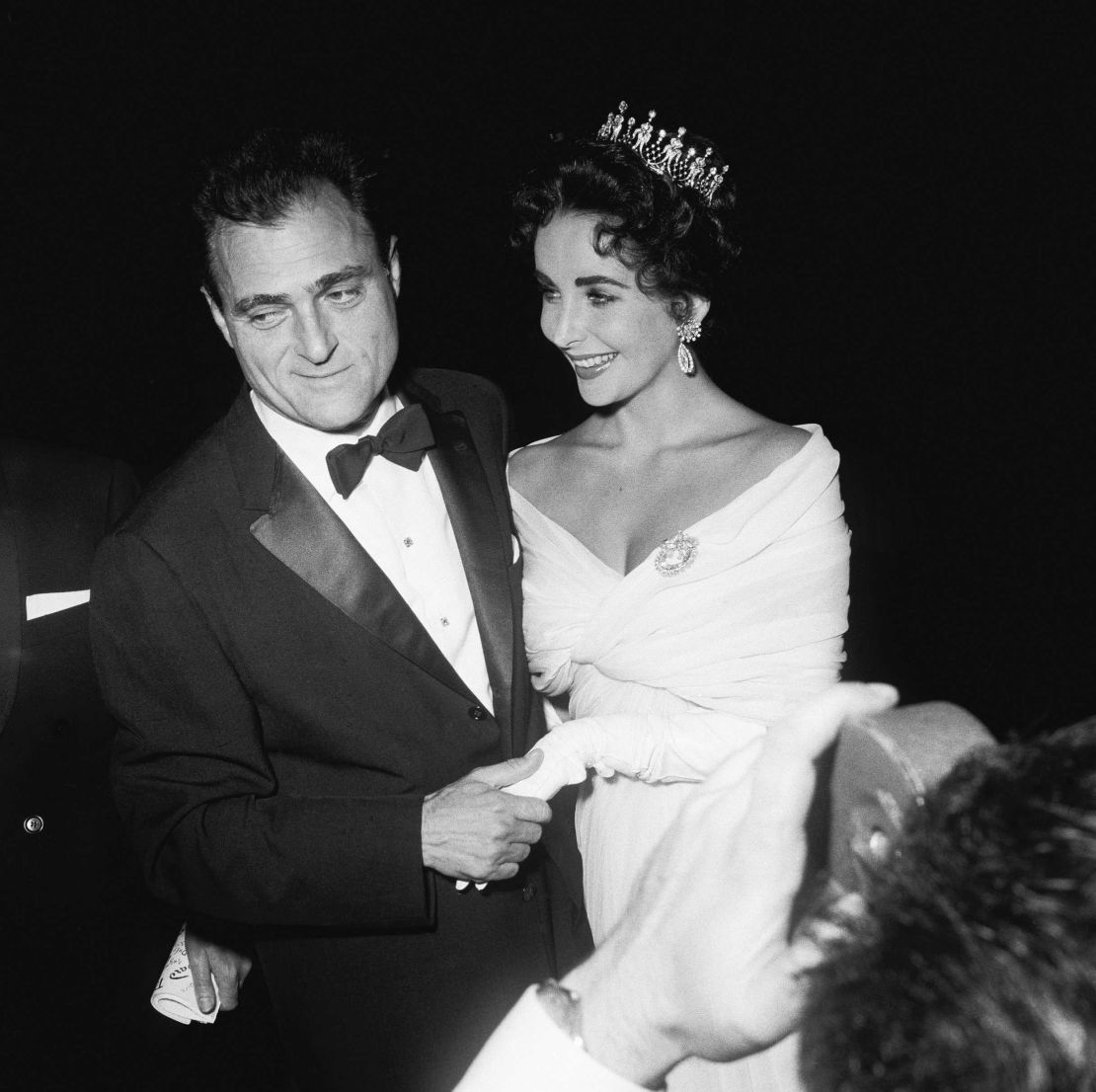 Elizabeth Taylor swaddles herself in white for the 1957 festival, accessorizing with a modest crown and her third husband, producer Mike Todd.