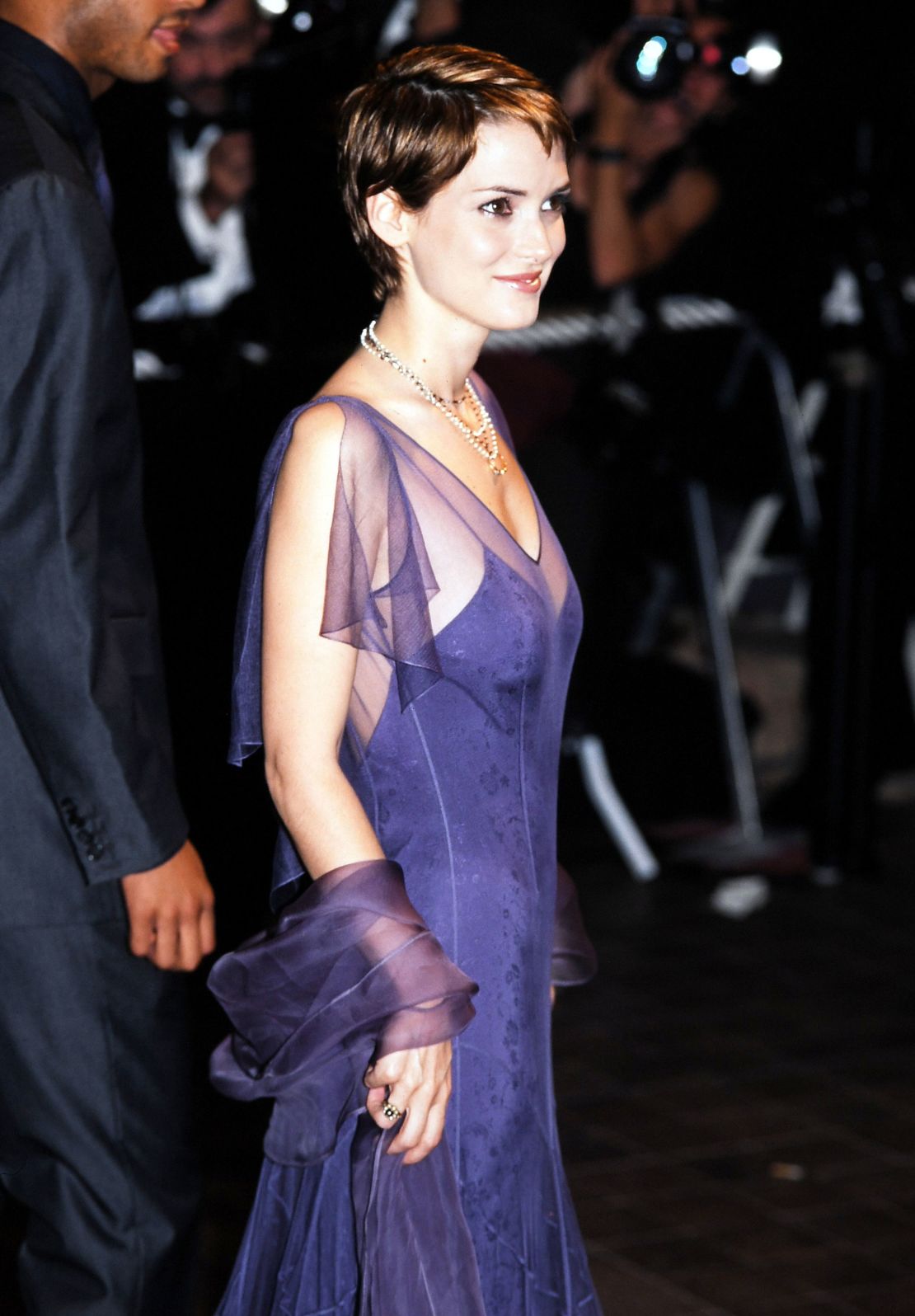 Winona Ryder at the 51st Cannes film festival in 1998 wearing a purple organza dress.