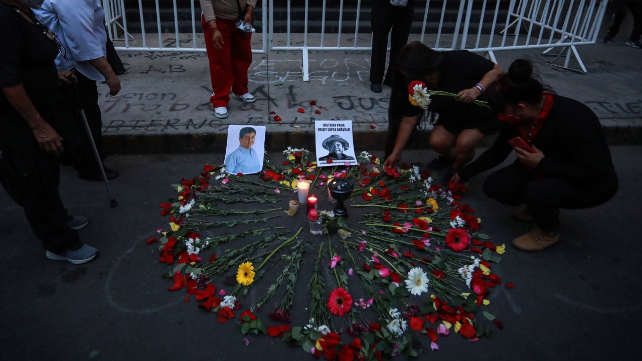 People place flowers next to the pictures of murdered journalists Luis Enrique Ramirez and Fredy Lopez Arevalo in Mexico City on May 09, 2022. 