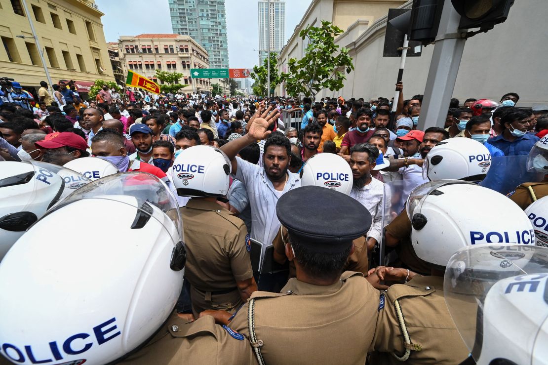 Government supporters and police confront each other outside the President's office in the Sri Lankan capital.