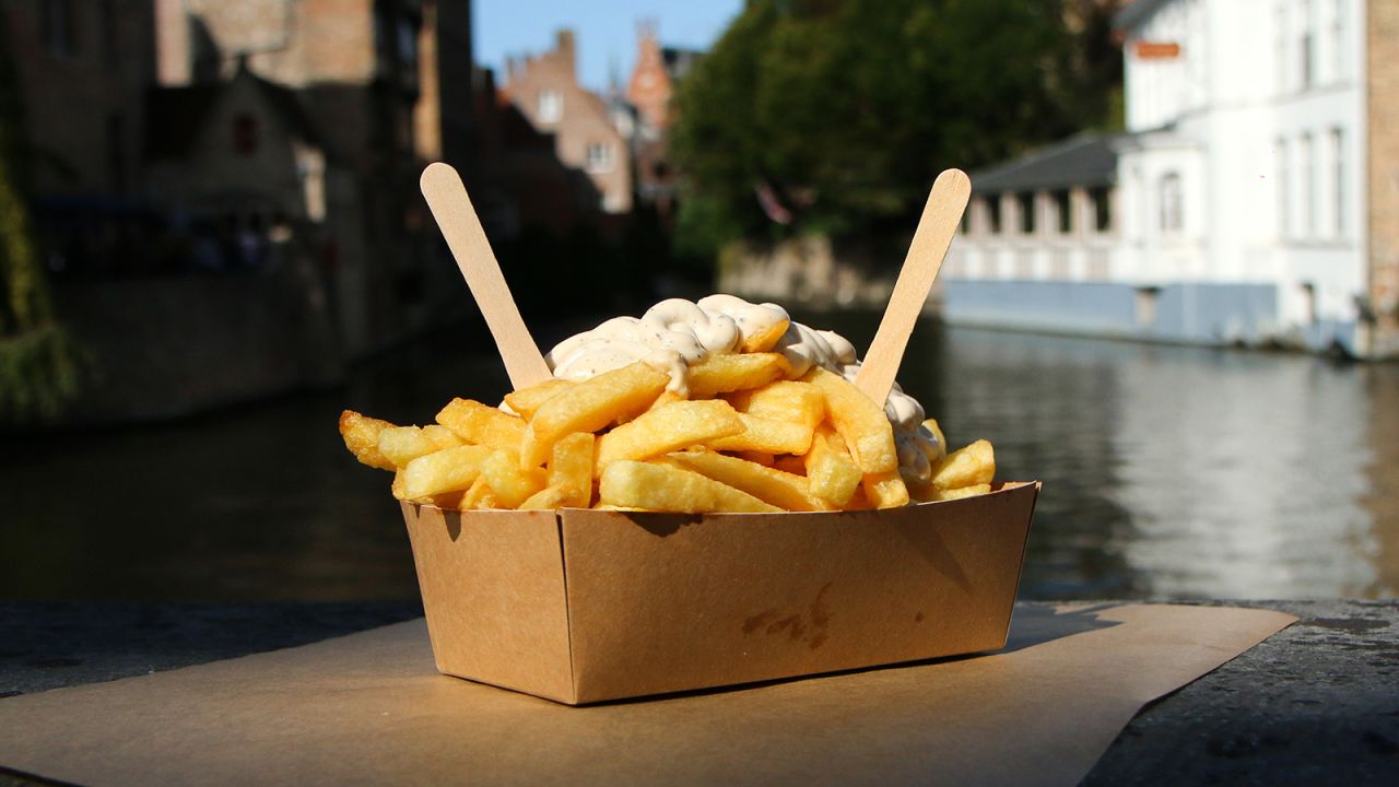 <strong>French fries (Belgium and France):</strong> They're named for the cut of the potato, not the nation. The fries in this particular photo are a traditional street food snack in Bruges, Belgium, and go with pepper sauce.