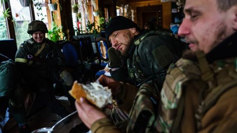 Yaroslav Amosov, resting his head on his hands, with the rest of his fellow Ukrainian soldiers as they prepare to confront Russian forces in Irpin, Ukraine.