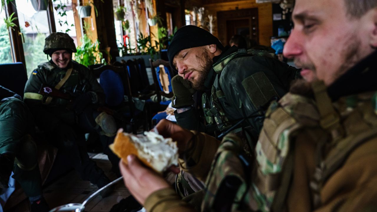 Yaroslav Amosov, resting his head on his hands, with the rest of his fellow Ukrainian soldiers as they prepare to face Russian forces in Irpin, Ukraine.