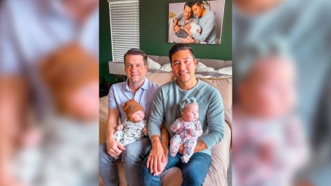 Chris (left) and Bryan Lambillotte pose with their newborn twins, Brecon and London.
