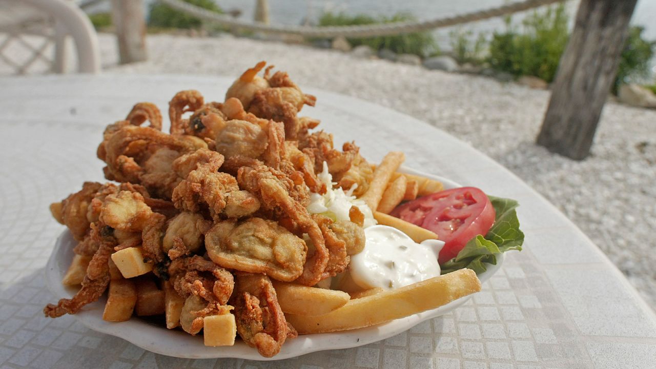 <strong>Fried clams (New England):</strong> Roadside clam shacks dot New England. Whole clam bellies are dipped in milk and then dredged in a cornmeal-flour breading before frying.