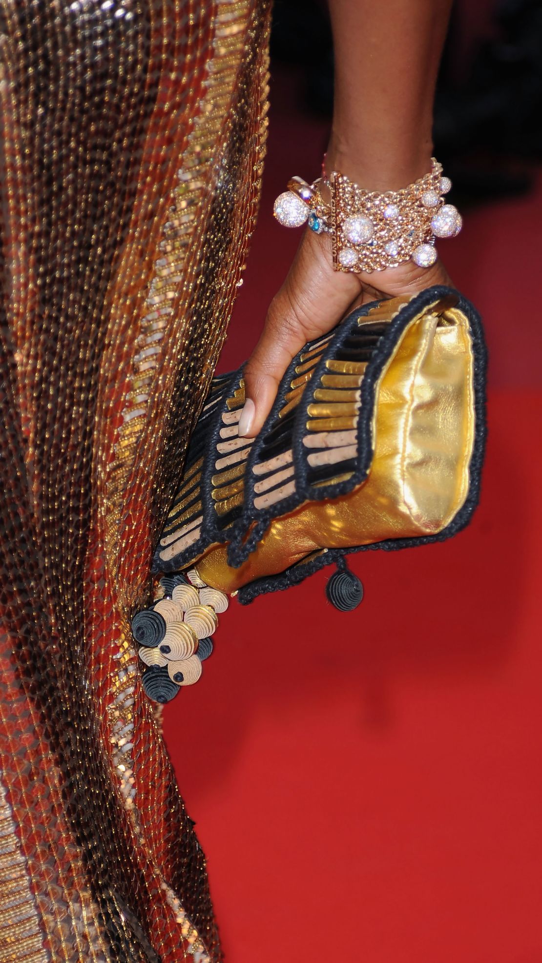 A detail of Naomi Campbell's bracelet and clutch.