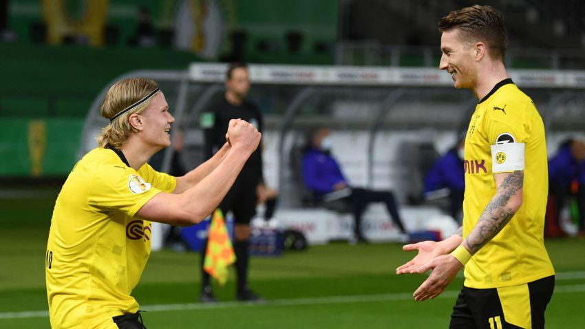 Dortmund's Norwegian forward Erling Braut Haaland (L) celebrates with Dortmund's German forward Marco Reus scoring during the German Cup (DFB Pokal) final football match RB Leipzig v BVB Borussia Dortmund, in Berlin on May 13, 2021. - RESTRICTIONS: ACCORDING TO DFB RULES IMAGE SEQUENCES TO SIMULATE VIDEO IS NOT ALLOWED DURING MATCH TIME. MOBILE (MMS) USE IS NOT ALLOWED DURING AND FOR FURTHER TWO HOURS AFTER THE MATCH. == RESTRICTED TO EDITORIAL USE == FOR MORE INFORMATION CONTACT DFB DIRECTLY AT +49 69 67880 (Photo by ANNEGRET HILSE / POOL / AFP) / RESTRICTIONS: ACCORDING TO DFB RULES IMAGE SEQUENCES TO SIMULATE VIDEO IS NOT ALLOWED DURING MATCH TIME. MOBILE (MMS) USE IS NOT ALLOWED DURING AND FOR FURTHER TWO HOURS AFTER THE MATCH. == RESTRICTED TO EDITORIAL USE == FOR MORE INFORMATION CONTACT DFB DIRECTLY AT +49 69 67880 / RESTRICTIONS: ACCORDING TO DFB RULES IMAGE SEQUENCES TO SIMULATE VIDEO IS NOT ALLOWED DURING MATCH TIME. MOBILE (MMS) USE IS NOT ALLOWED DURING AND FOR FURTHER TWO HOURS AFTER THE MATCH. == RESTRICTED TO EDITORIAL USE == FOR MORE INFORMATION CONTACT DFB DIRECTLY AT +49 69 67880 (Photo by ANNEGRET HILSE/POOL/AFP via Getty Images)