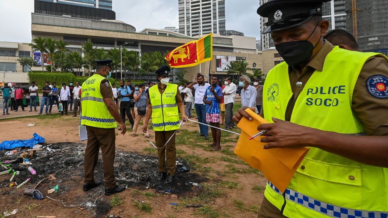 Police at the scene of clashes between government supporters and demonstrators in Colombo on May 10. 
