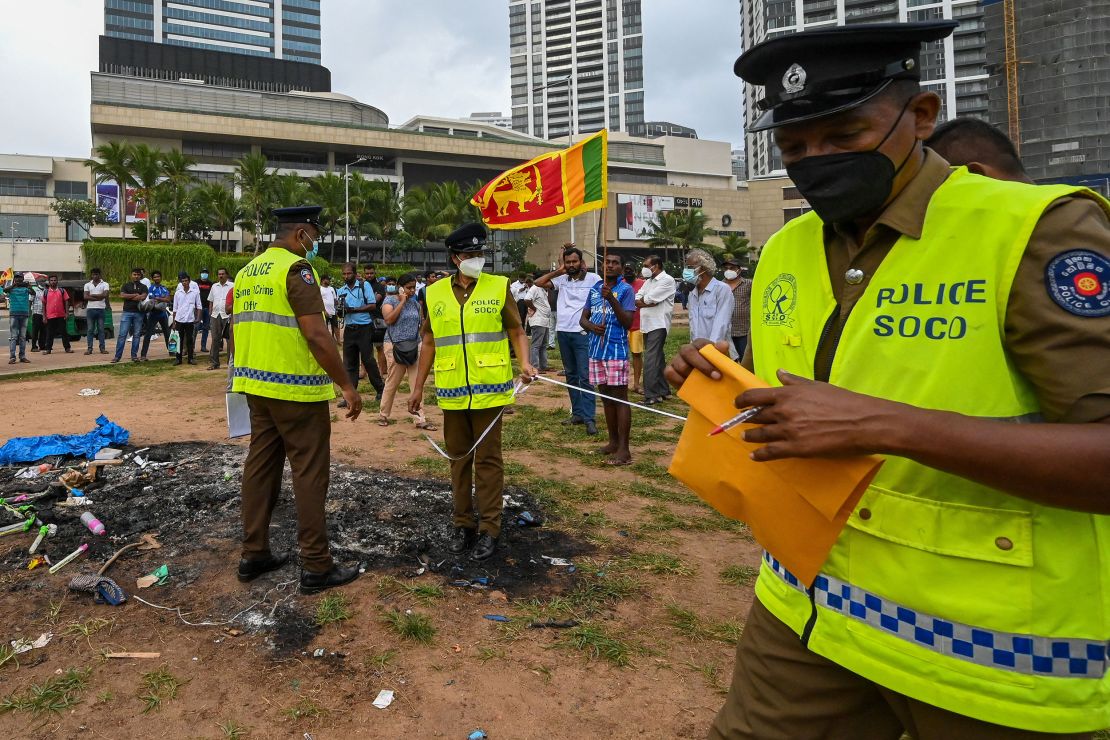 Police at the scene of clashes between government supporters and demonstrators in Colombo on May 10. 