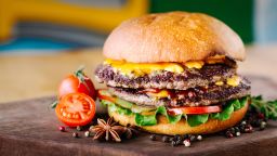 Delicious burgers with beef, tomato, cheese and lettuce