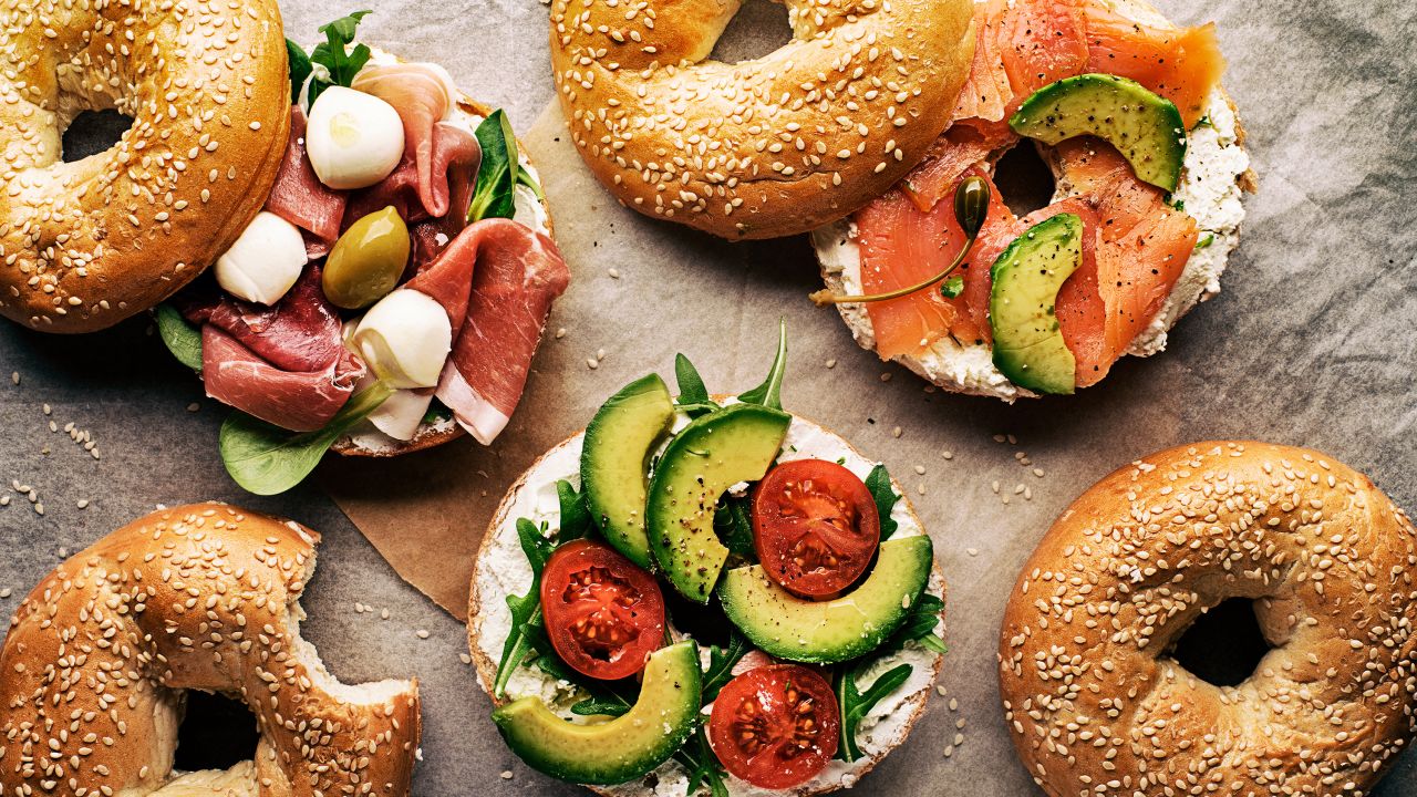 Eat only half of a bagel sandwich with avocado, salmon, prosciutto and mozzarella and refrigerate the leftovers for the next day. 