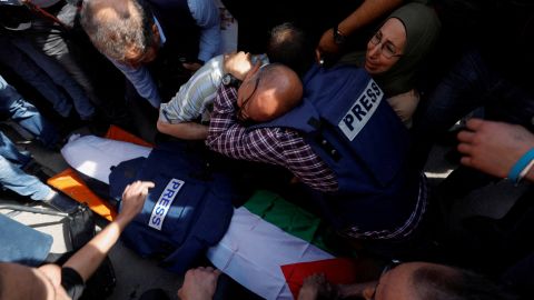 Mourners, including journalists, reacted next to the body of Al Jazeera reporter Shireen Abu Akleh.