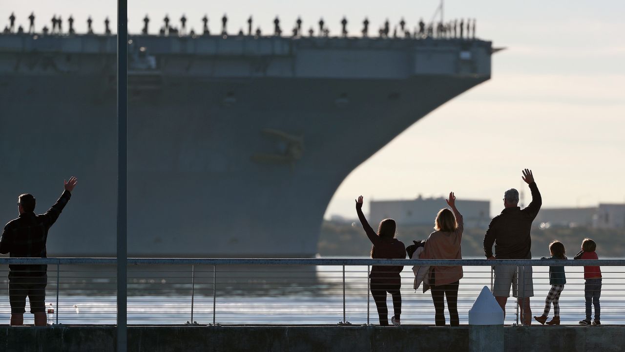 Families wave to the aircraft carrier USS Abraham Lincoln as it deploys from San Diego in January.