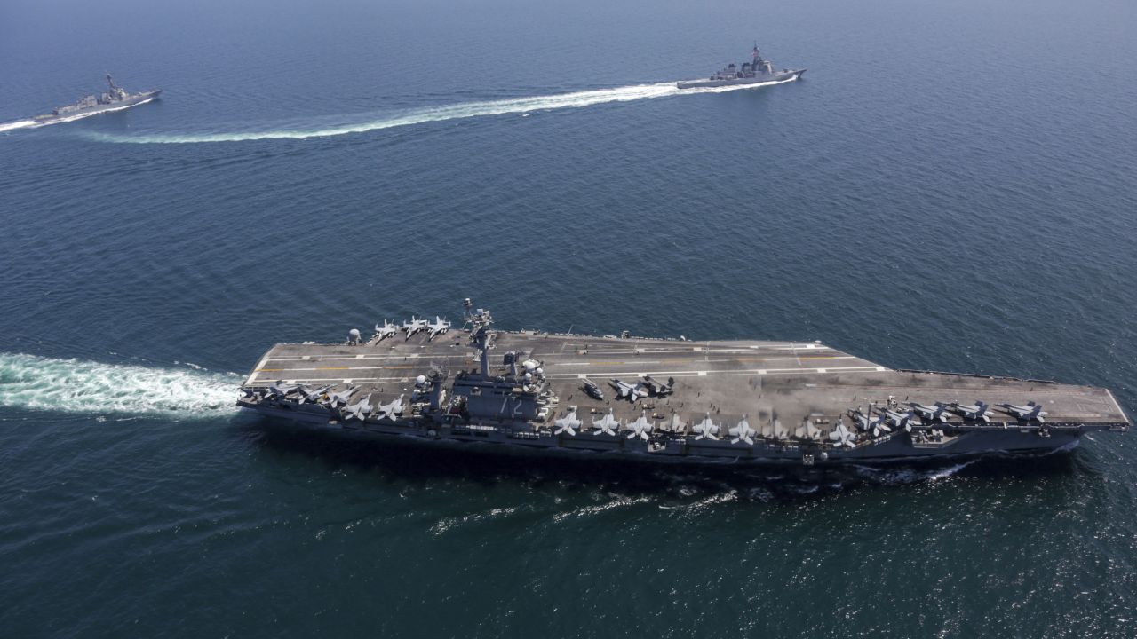 The USS Abraham Lincoln, front, and other warships sail in formation during a US-Japan bilateral exercise.