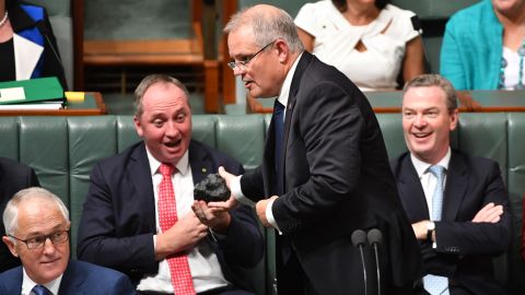 Then Treasurer Scott Morrison hands Deputy Prime Minister Barnaby Joyce a lump of coal during Question Time in Canberra on Feb. 9, 2017.