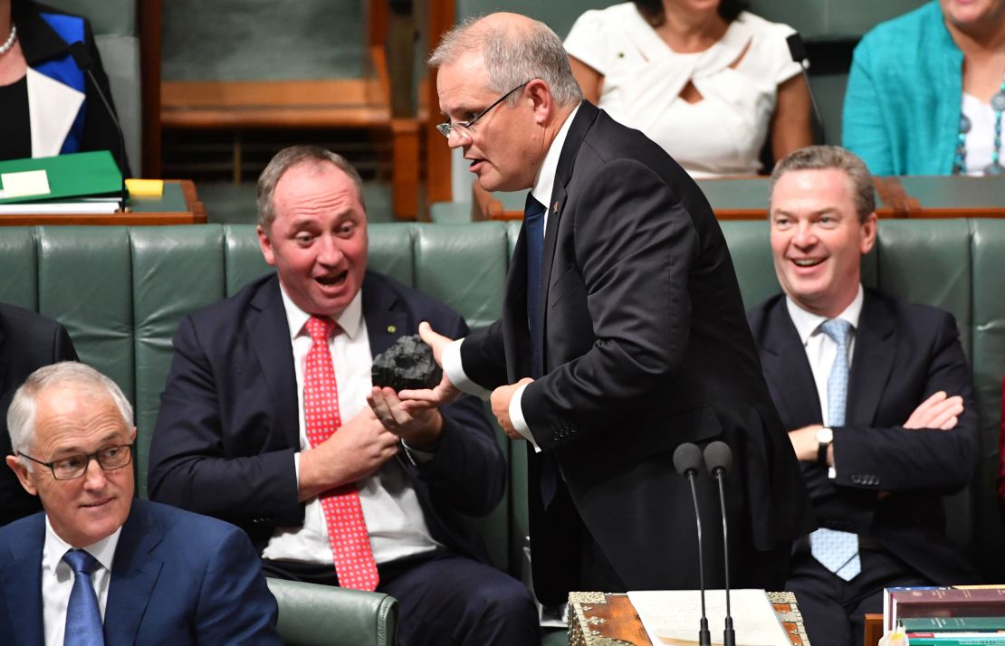 Then Treasurer Scott Morrison hands Deputy Prime Minister Barnaby Joyce a lump of coal during Question Time in Canberra on Feb. 9, 2017.