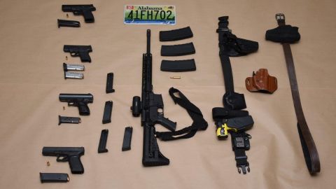 Four handguns, a loaded AR-15 style rifle, handcuffs and a Taser were among the items found inside the wrecked Cadillac.